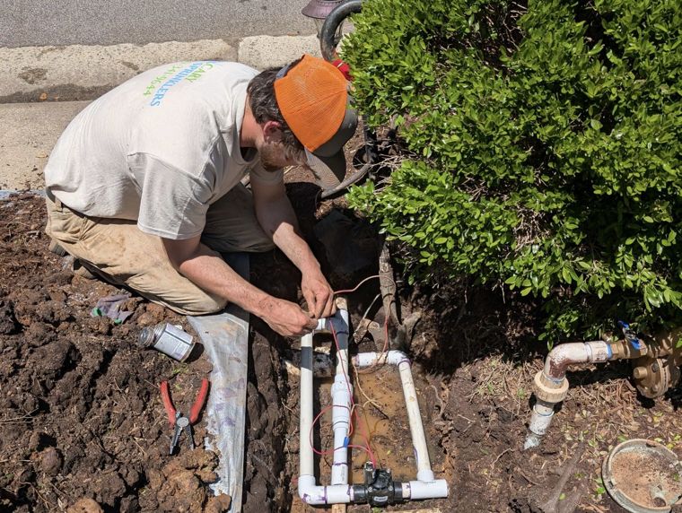 Cary Sprinklers technician repairing an irrigation valve in the Triangle, NC