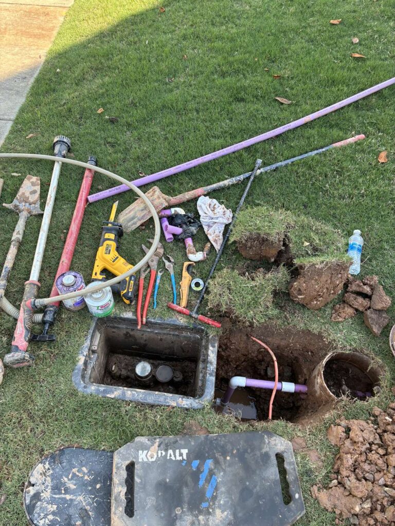 Purple reclaimed-water irrigation mainline repair in progress on a lawn in Cary, NC